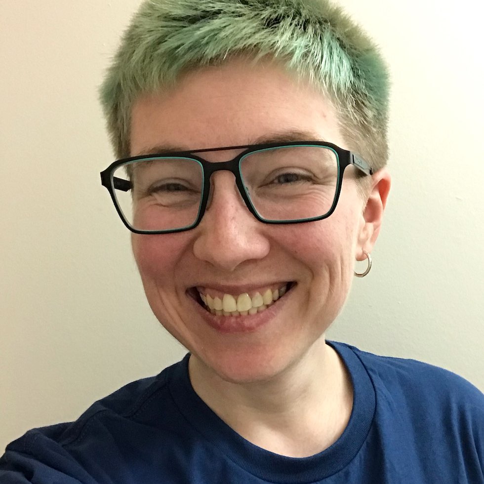 Sam, a smiling white person with short blue hair